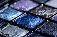Colorful eyeshadow palette with shimmery blue purple silver makeup cosmetics in compact case for beauty and fashion applications.
