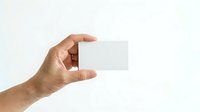 Hand holding blank white square card or paper against neutral background for mockup and branding purposes.