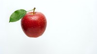 Fresh red apple with green leaf isolated on white background for healthy eating and nutrition concepts.