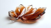Elegant amber glass leaf-shaped decorative bowl with translucent petals on white background, isolated for home decor and tableware design projects.