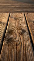 Rustic weathered wooden planks with natural grain patterns and knots creating warm textured surface for product display and design backgrounds.