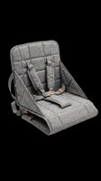 Portable gray fabric booster seat with safety straps and padded support, isolated on transparent background. Ready for clipart, print-on-demand, and design projects.