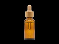 Amber glass dropper bottle with bamboo cap, isolated on transparent background. Great for skincare, cosmetic branding, stickers, print on demand, and T-shirt design.