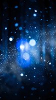 Abstract blue bokeh lights with sparkling particles and glowing orbs creating dreamy atmosphere for digital backgrounds and creative projects.