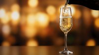 Champagne being poured into elegant flute glass against warm golden bokeh background, celebration and festive occasion beverage for events and parties.