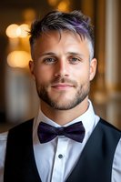 Stylish male model with purple highlights and bow tie poses in formal attire against blurred bokeh background. Professional portrait showcasing modern fashion trends.