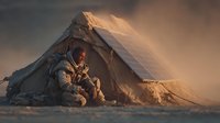Astronaut in spacesuit sitting beside makeshift shelter with solar panel in desolate, dusty landscape during golden hour, suggesting survival on alien planet.