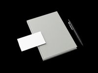 Closed notebook with blank white page insert and black pen isolated on transparent background, ready for t-shirt design, clipart, stickers, and print-on-demand projects.