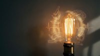 Glowing vintage Edison bulb casting warm light on dark wall with sketched science and medical icons, symbolizing innovation and creative thinking.