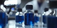 Laboratory glass bottles with blue liquid samples on reflective surface in modern research facility for scientific analysis and chemical testing.