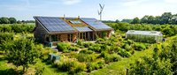 Modern eco-friendly house with solar panels surrounded by lush green garden and trees showcasing sustainable living and renewable energy technology.