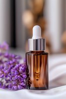 Brown glass dropper bottle with essential oil or serum next to fresh purple lavender flowers on white fabric, soft bokeh background for spa and beauty products.