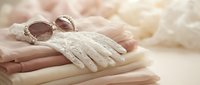 Elegant white lace gloves and vintage sunglasses resting on gentle hands, perfect for bridal fashion, retro style accessories, and romantic wedding themes.