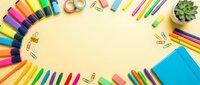 Colorful markers, pencils, sticky notes, paper clips, and succulent plant arranged on pale yellow background with copy space for creative projects.