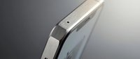 Modern smartphone edge showing sleek metallic frame and curved glass display on neutral background for technology and mobile device concepts.