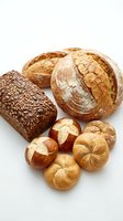Assorted artisan breads including seeded loaf, crusty round boule, and dinner rolls isolated on white background for bakery, food, and culinary design projects.