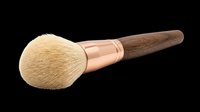 Soft makeup brush with natural bristles, rose gold ferrule, and wooden handle isolated on transparent background. Ready for beauty product design, tutorials, packaging, and print-on-demand applications.