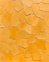 Abstract orange cracked surface pattern with irregular geometric shapes and dark lines creating a mosaic-like texture. Seamless design for backgrounds and wallpapers.