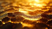 Glowing golden particles with water droplets create magical bokeh effect on dark background. Macro photography reveals intricate details of light and texture.