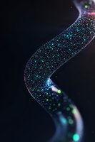 Glowing curved ribbon with sparkling turquoise and purple particles floating in dark space creates magical atmospheric effect for fantasy designs.