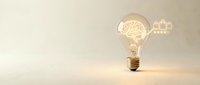Creative lightbulb with glowing brain filament symbolizing innovation and bright ideas on neutral background for business and education concepts.