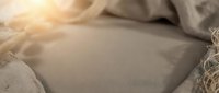 Soft neutral bedding with layered linen textures and warm natural light, suitable for home decor, lifestyle, and interior design projects.