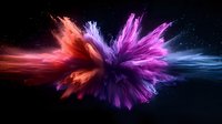 Vibrant explosion of colorful powder against black background, featuring dynamic motion of red, purple, and blue particles creating abstract cosmic effect.