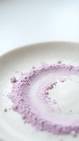 Lavender powder swirl in white ceramic bowl, close-up view for cosmetics, skincare, wellness, and beauty product photography.