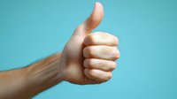 Hand showing thumbs up gesture against turquoise background, expressing positivity, approval and success in minimalist composition.