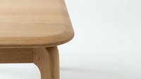 Modern wooden chair detail showcasing natural oak grain and minimalist Scandinavian design craftsmanship for contemporary interior furniture concepts.