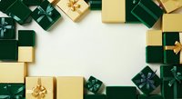 Wrapped gift boxes in emerald green and gold with golden ribbons arranged on white background, flat lay composition with copy space for holiday, celebration, and seasonal marketing materials.