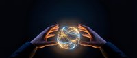 Hands holding glowing energy sphere with golden light trails against dark background, representing power, innovation, and technology for business and science concepts.
