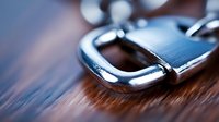 Close up view of metal padlock on wooden surface with selective focus and blurred background, highlighting security and protection concept.