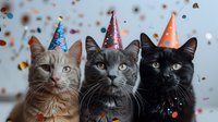 Three cats wearing colorful party hats with confetti falling in background, celebrating a special occasion in playful festive mood.