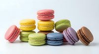 Colorful French macarons in various flavors arranged on white background. Sweet pastry dessert collection for bakery menu, cafe advertising, culinary projects.