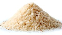 Heap of raw brown sugar granules isolated on white background, perfect for baking, cooking, and food ingredient photography.