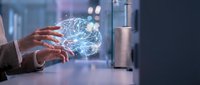 Businessman hands holding glowing digital brain with neural network connections in modern office environment representing artificial intelligence and innovation.