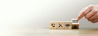 Caucasian male hand arranging wooden cubes with customer service icons and open everyday sign on light background for business support concept.
