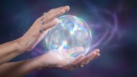 Hands protecting glowing energy sphere with rainbow light effects against cosmic purple background for spiritual healing concepts.