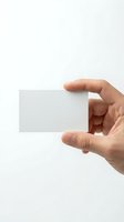 Hand holding blank white business card mockup on clean background for branding and corporate identity design projects.