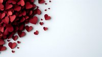Red paper hearts scattered on white background creating romantic corner composition, suitable for Valentine's Day cards, wedding invitations and love messages.