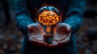 Glowing light bulb with brain-shaped filament floating above cupped hands, surrounded by magical blue sparkles and orange energy, symbolizing innovation and creativity.