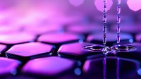 Water drops falling on hexagonal surface with purple and pink neon lighting creating dramatic macro photography effect. Liquid splashes form crown-like shapes against geometric pattern.