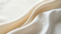 Creamy white liquid with smooth flowing waves and droplets creating elegant curves and splashes against soft background for dairy and beverage concepts.