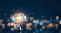 Creative lightbulb with glowing brain inside surrounded by sparkling lights and bokeh effects on dark blue background for innovation concepts.