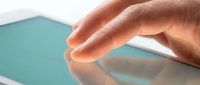 Close-up of a hand touching a turquoise surface, showcasing tactile interaction and smooth texture for design, technology, or product presentation concepts.