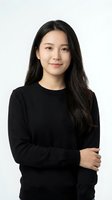 Professional Asian businesswoman in black sweater with crossed arms smiling confidently on white background for corporate headshot and business marketing.