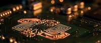 Close-up of illuminated microchip processor on circuit board with warm golden lights creating bokeh effect in modern technology background.