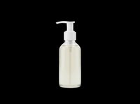 Clear glass pump bottle with pale liquid and white dispenser pump, isolated on transparent background, ready for cosmetics, skincare, soap, or sanitizer product design and packaging mockups.