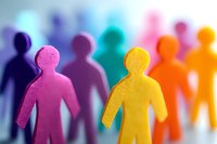 Colorful paper cutout figures standing in row symbolizing diversity, unity and teamwork. Vibrant silhouettes represent community and social connection.